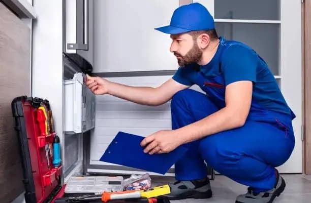 Technician working on a refrigerator
