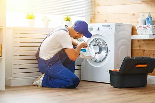Technician working on a washing machine